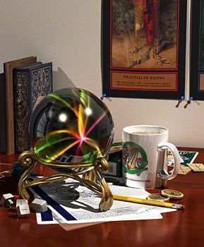 table full of divination tools, with the crystal ball running a screen saver